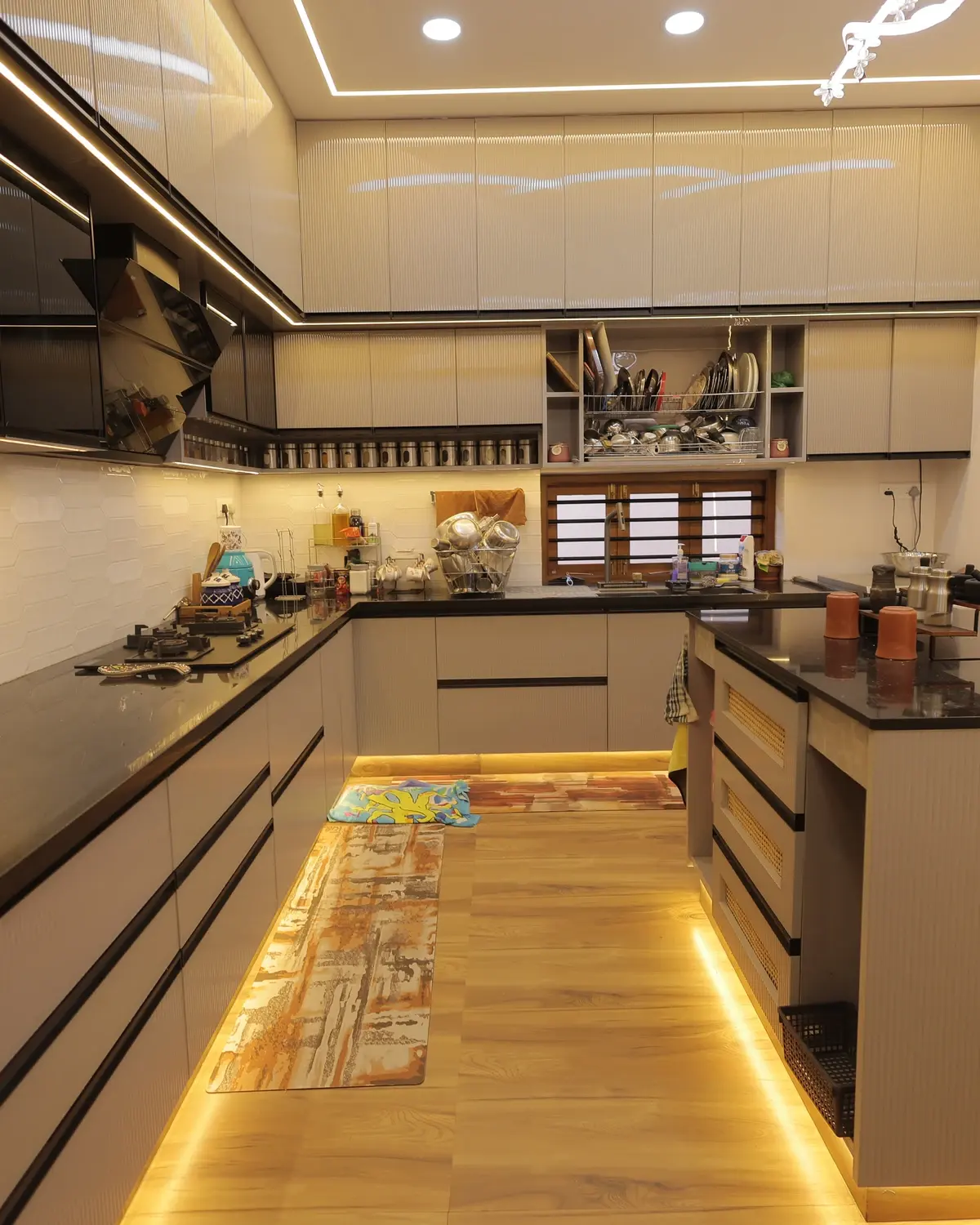 Finished kitchen with polished granite island counter and modular cabinetry — Sunil Residence