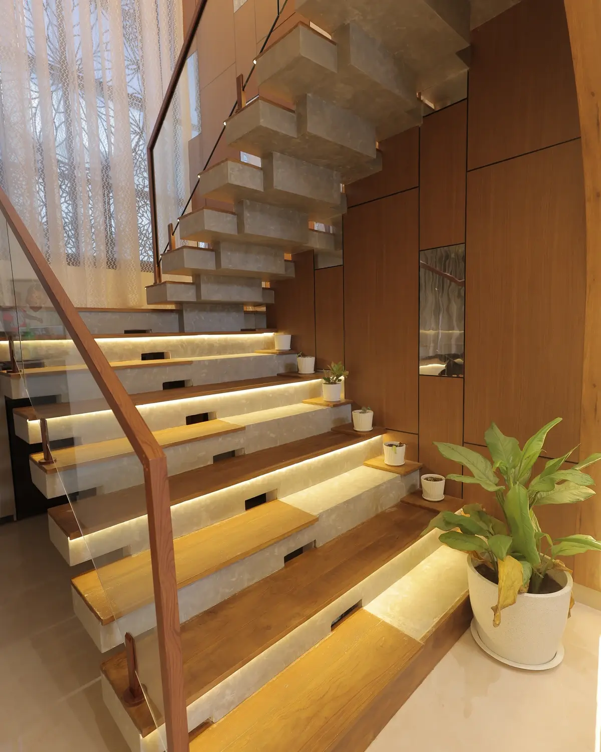 Toughened glass staircase balustrade, wood handrail, and illuminated floating stairs — Sunil Residence